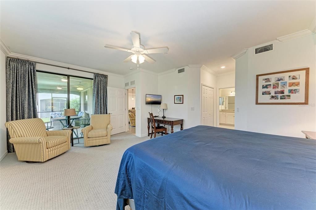 View from back wall in the Primary Bedroom to the sitting area, lanai and Primary Bathroom to the right