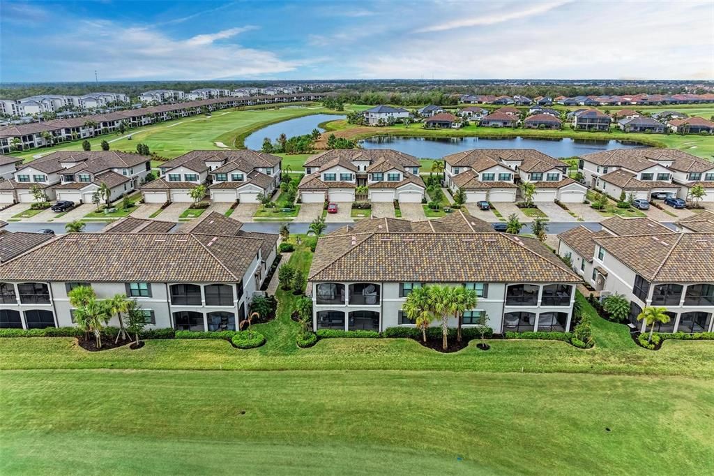 Aerial view from the back yard. Middle Building, Bottom, Left Unit with an expansive, 22x10 Lanai with Motorized, Hurricane Proof Screens and tinted Sliding Doors to protect fabric and reduce glare