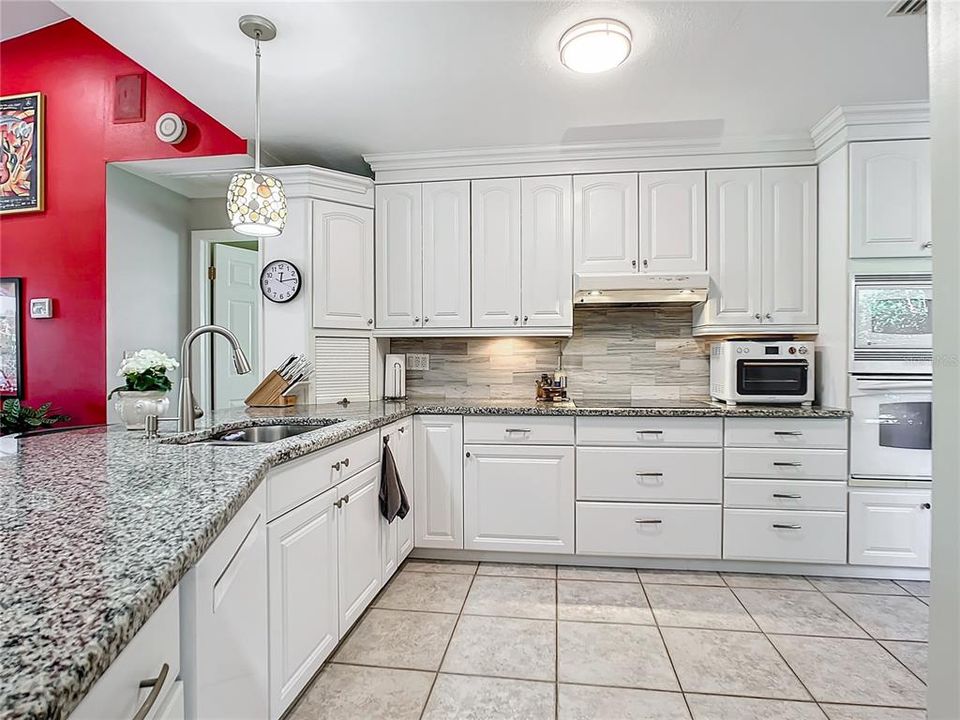 Updated white kitchen with granite counters