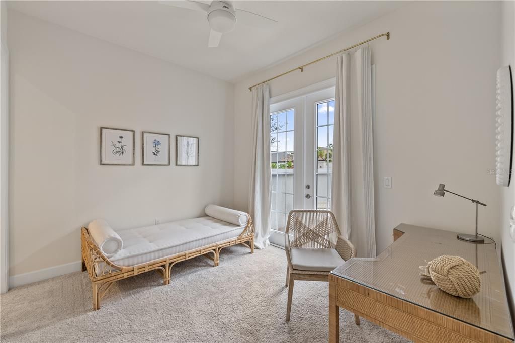 Bedroom 3 featuring French doors out to the courtyard.