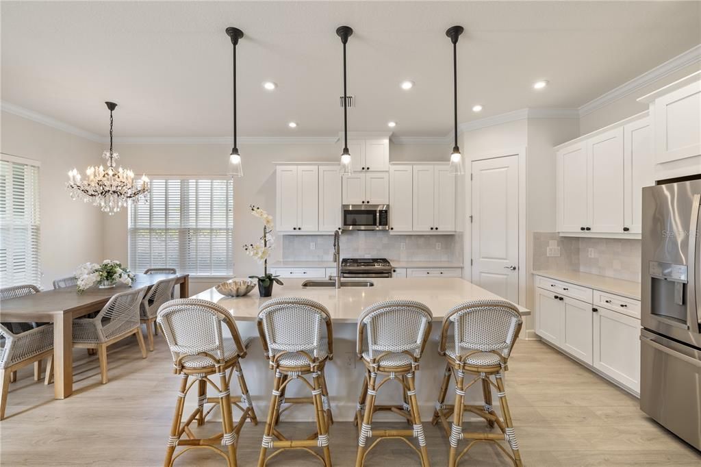 Kitchen featuring pendent and recess lighting.