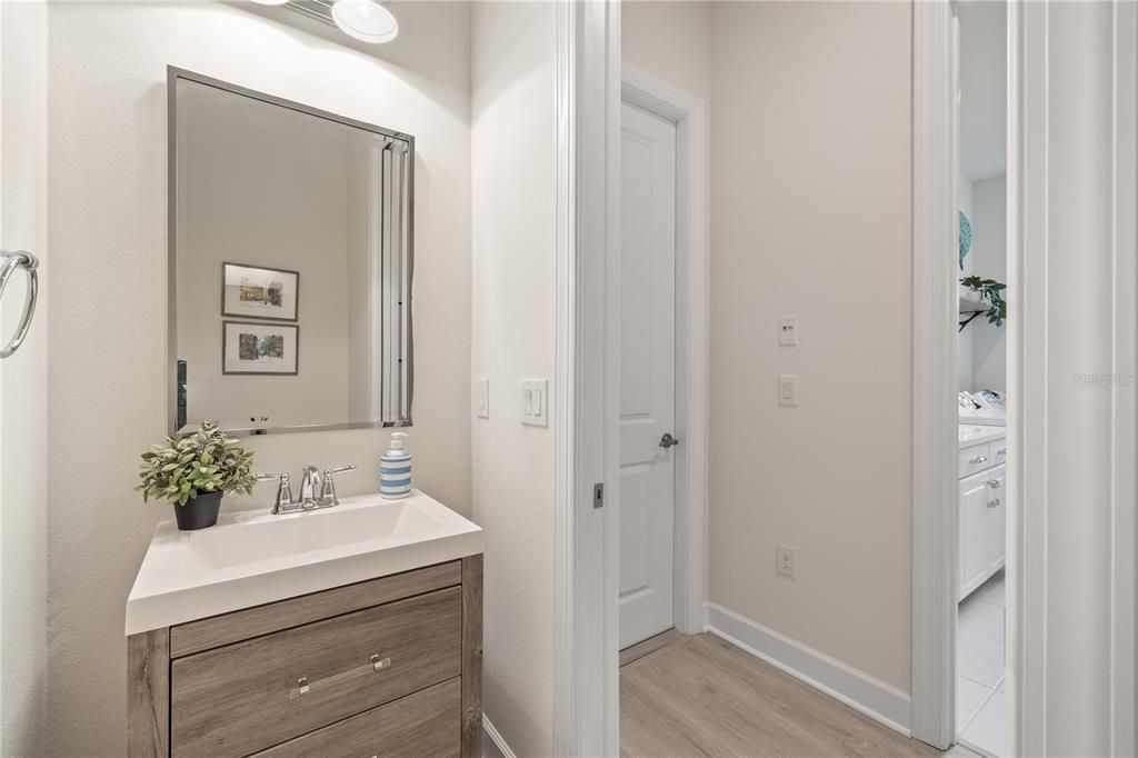 Half bathroom off the the garage next to the laundry room.