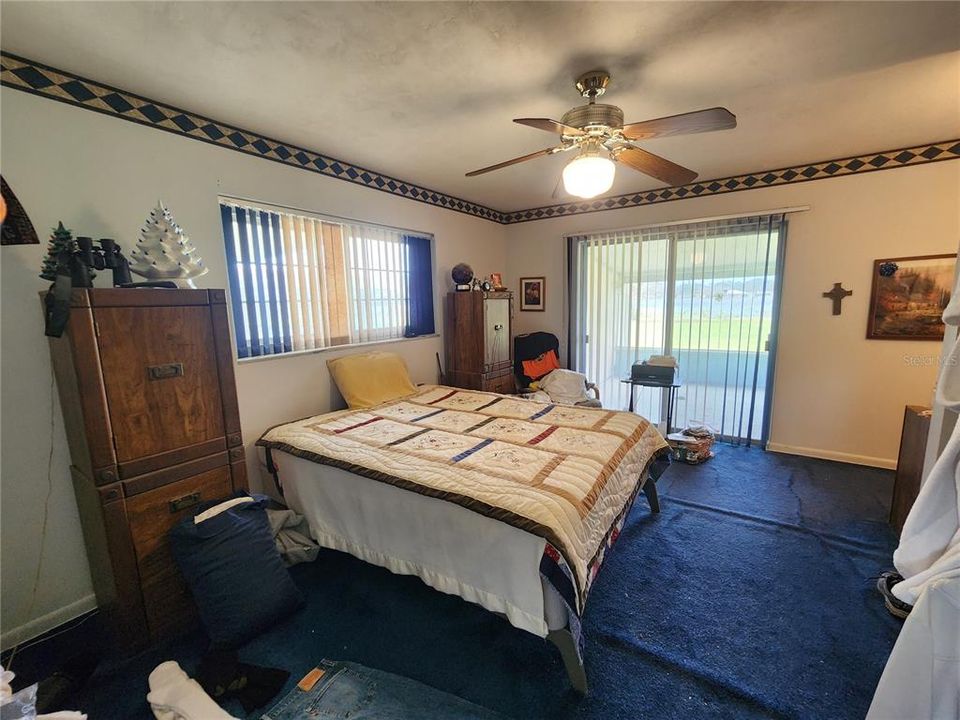 Primary bedroom suite towards private screened porch.