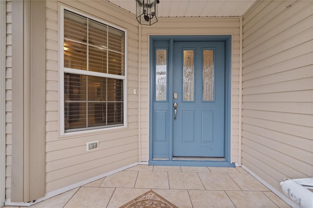 SCREEN ENCLOSED AND CERAMIC TILED FLOORING.  FRONT LEADED DOOR