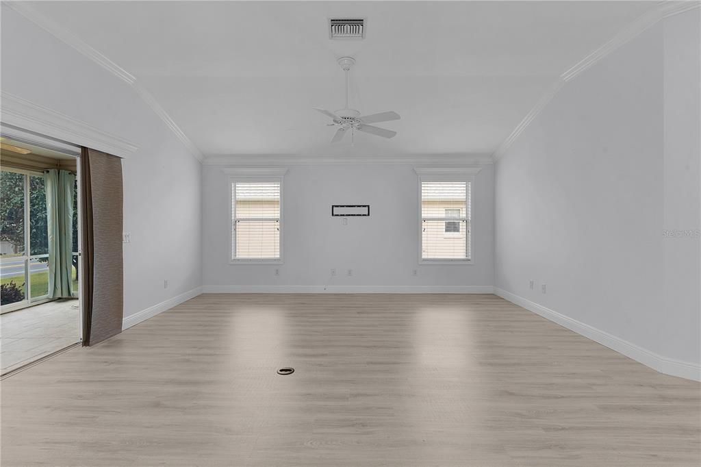 LIVING ROOM WITH LVP FLOORING AND ENTRANCE TO THE LANAI