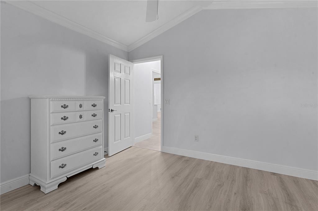 3RD BEDROOM/DEN WITH LVP FLOORING AND VAULTED CEILING