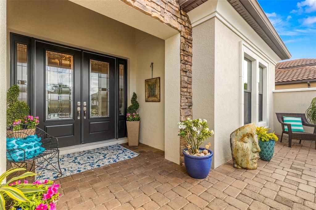 Beautiful front courtyard with high impact rated front doors and windows