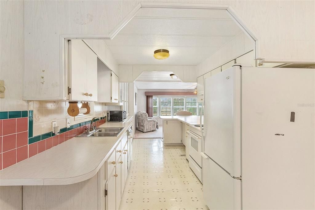 Galley kitchen opens up to a large family room