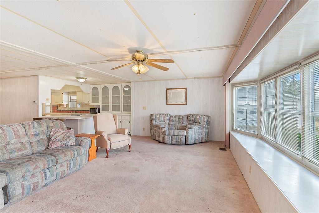 The living room features tons of windows filling the. home with natural light.