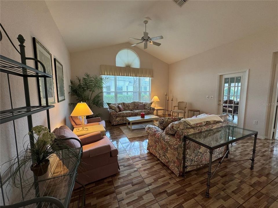 Great Room with high ceilings and large windows with entry to the lanai