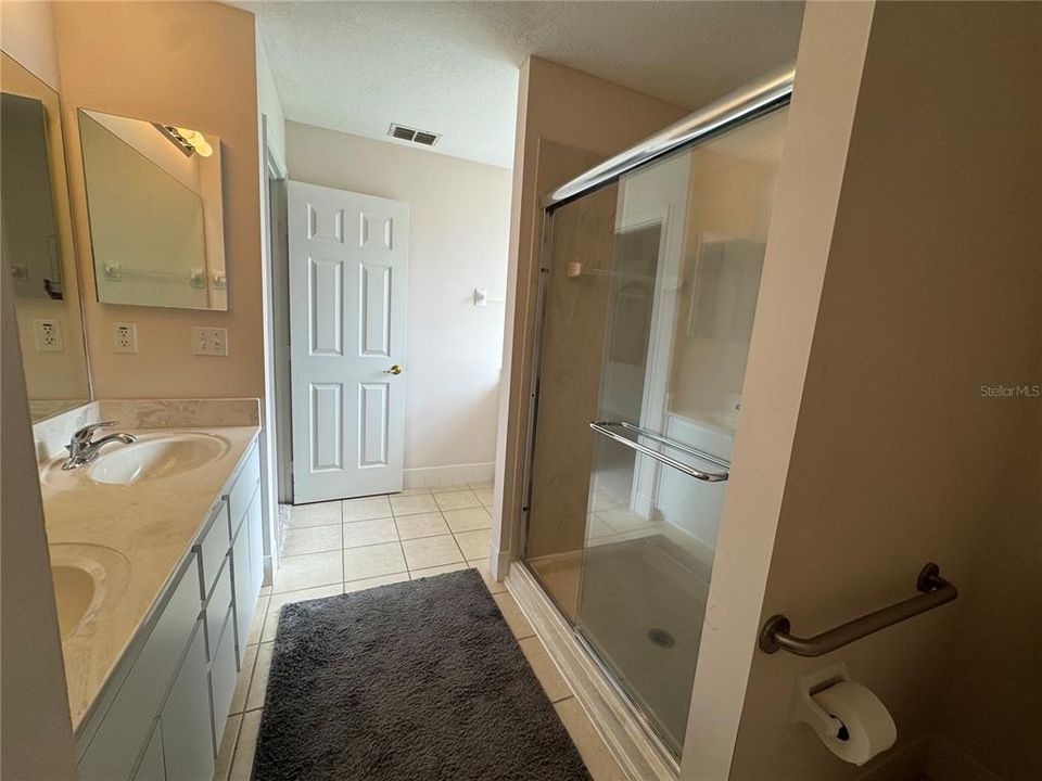 Primary bathroom with dual sinks and large shower