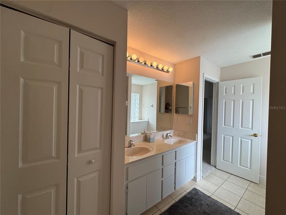 Linen closet in primary bathroom for additional storage