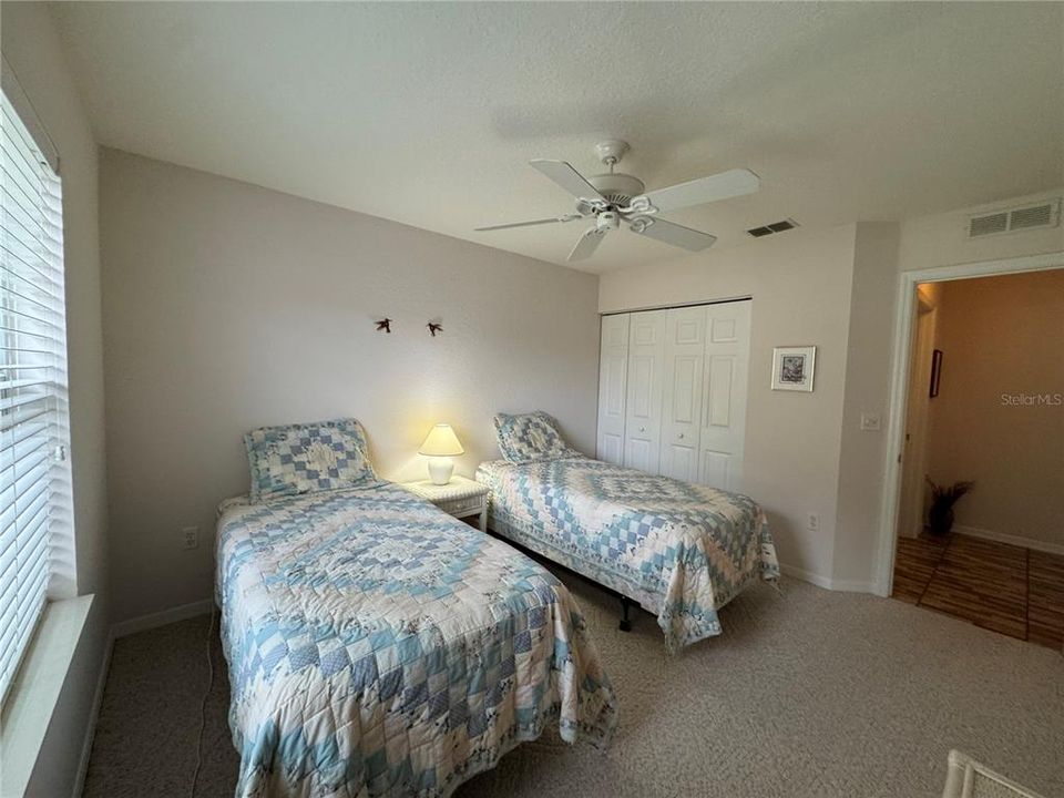 Guest Bedroom with closet and ceiling fan.