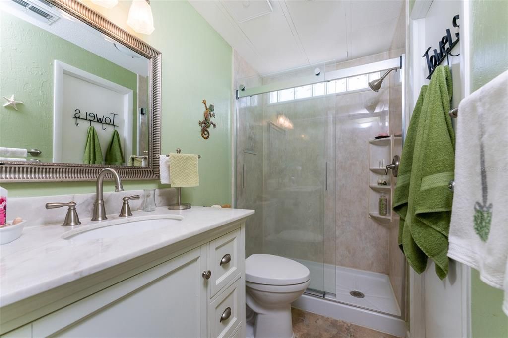 Guest bath has been nicely updated - vanity, mirror, toilet and shower surround!