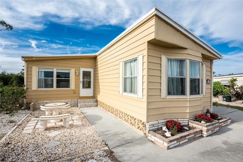 The property has a nice walkway to the front entrance with an outside seating area.