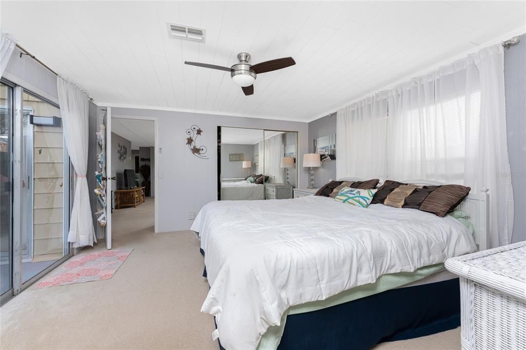 The master bedroom has large windows and a wall closet.