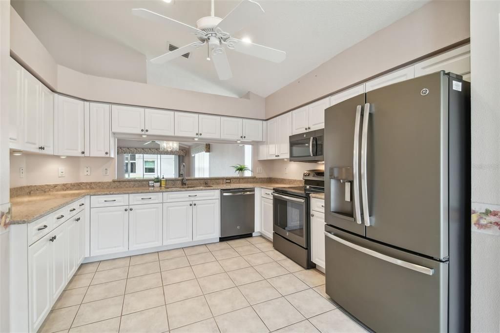 stainless steel appliance package with solid surface countertops undermount sink. Pull out shelves in the kitchen, under cabinet lighting and breakfast bar.