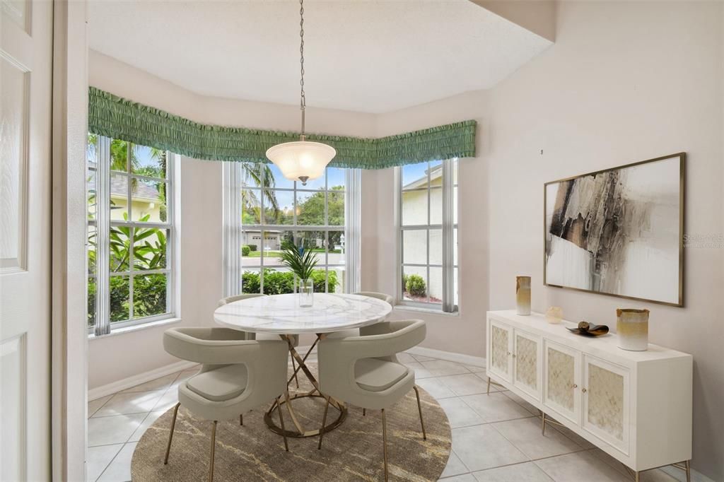 virtually staged breakfast nook with built in pantry with loads of natural light from the bay window! A beautiful space for your morning coffee!