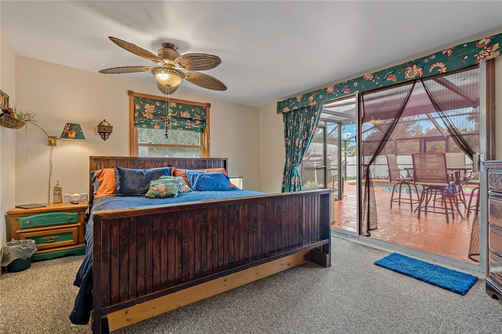 Florida Room used as 4th Bedroom with Ceiling Fan and Sliding Door to Pool and Screened Lanai.