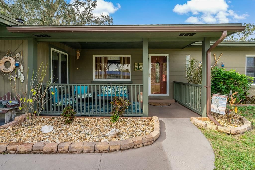 Front Walk up to covered front porch and newer Fiberglass Exterior door with Glasslite full view storm door.