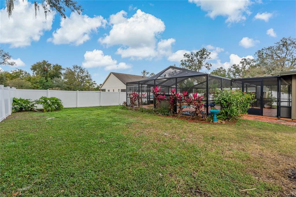 Beautiful White Vinyl Fencing encloses the large back yard.