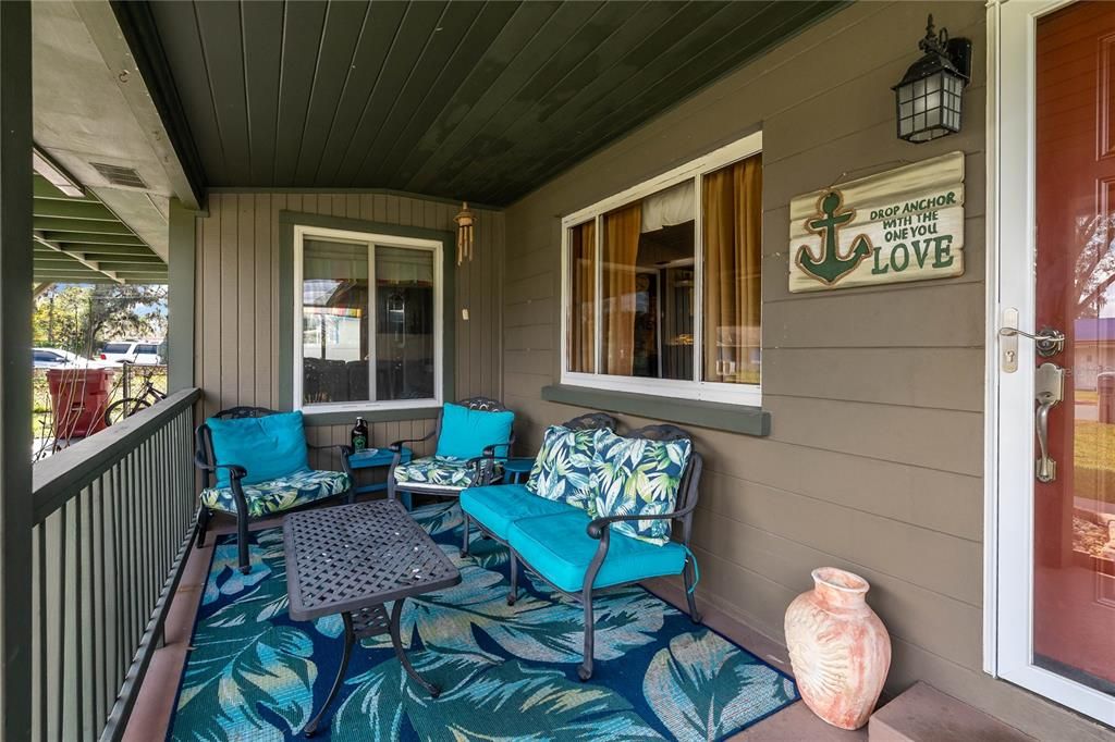 Covered Front Porch.  Window on right is Dining Room.  Window on left is Living Room.