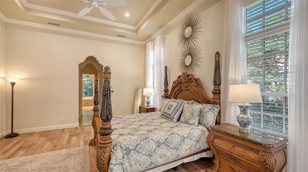 Beautiful coffered ceilings, rich crown molding, and hardwood floors make this Primary Suite a true Retreat.