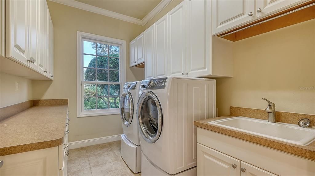 The Laundry Room is on the 1st floor.  It measures a delightful 8x13 with loads of cabinets.  The washer and dryer are a very young 2 years old.