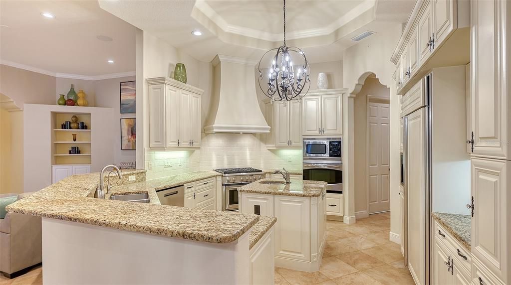 This cheerful and inviting kitchen is a delight, with a large center island and a walk in pantry that is HUGE