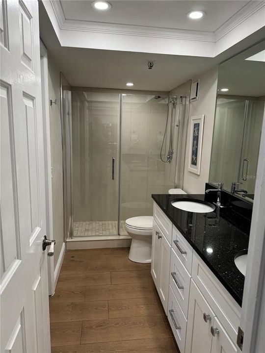 Guest bathroom with dual sinks and shaker cabinets