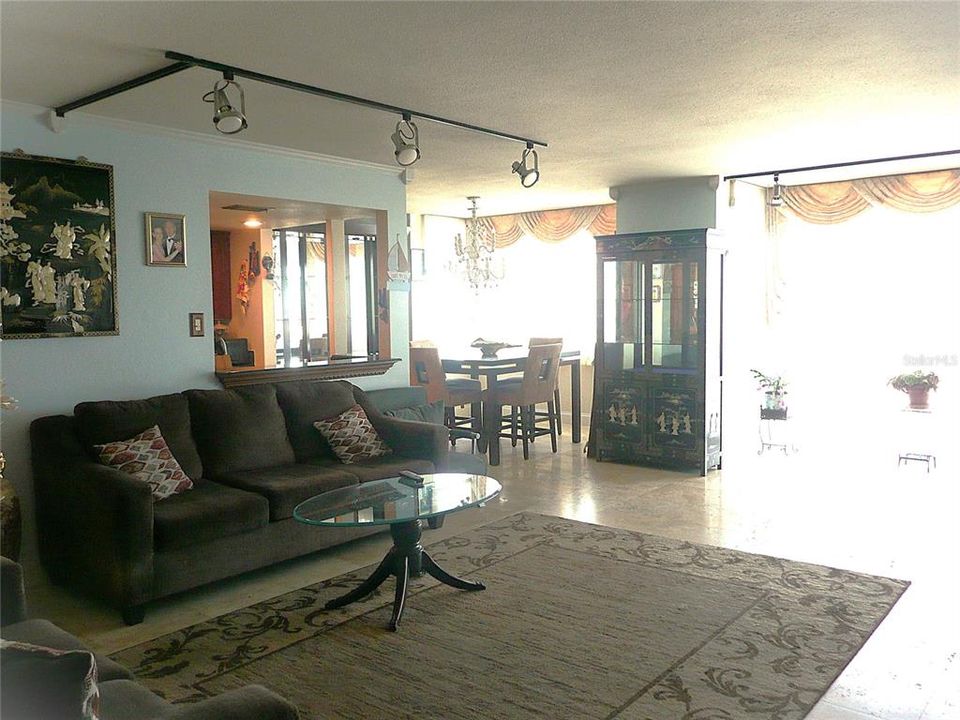 Living room that opens to dining room & imagination room with picture window views