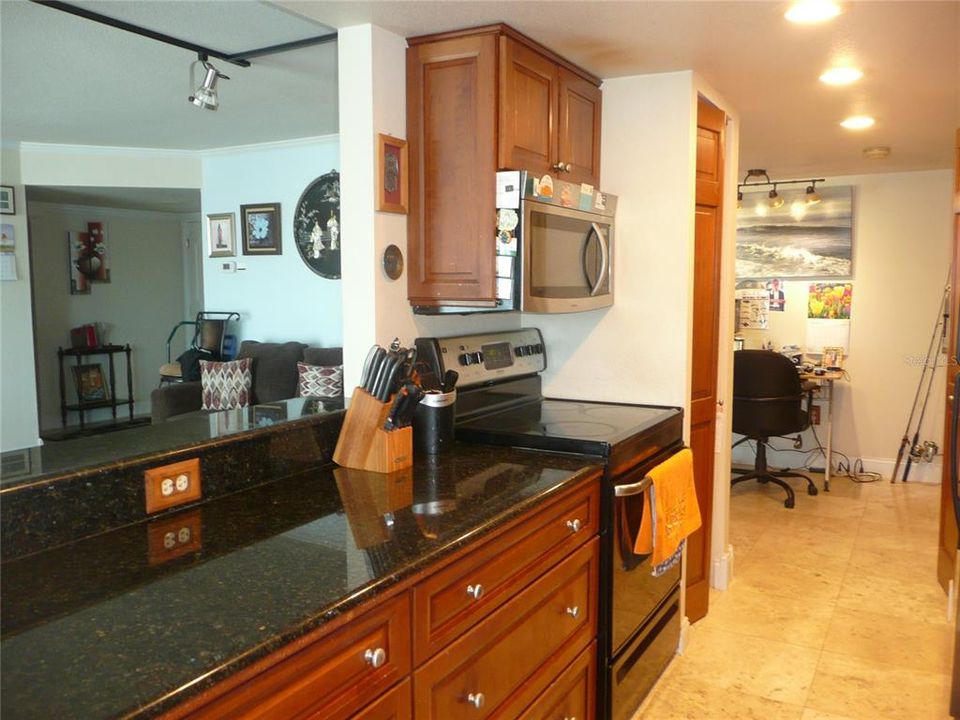 Full kitchen w/granite countertops and solid wood cabinetry.