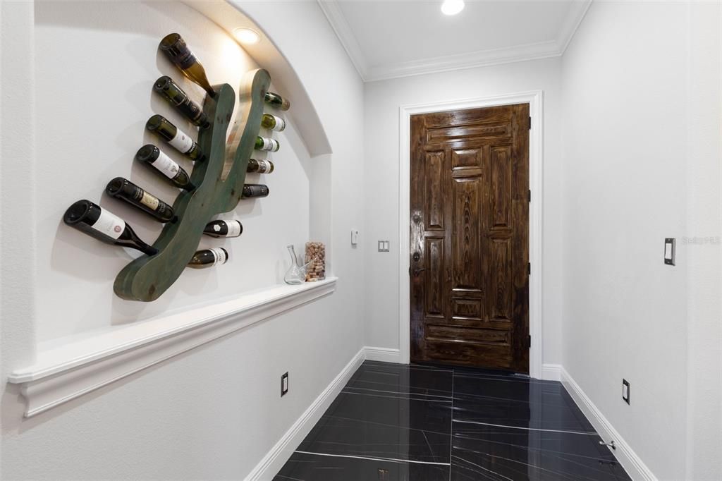 Entry foyer area with decorate lit niche