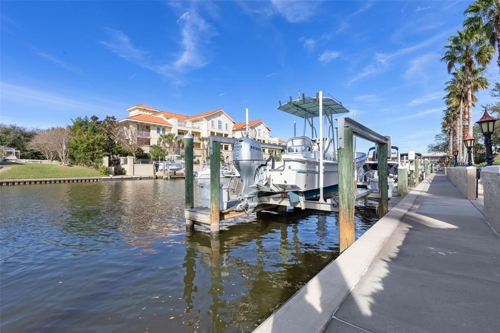 Boat slip with 10,000 lb boat lift, electric and water, and fiberglass dock box available separately.