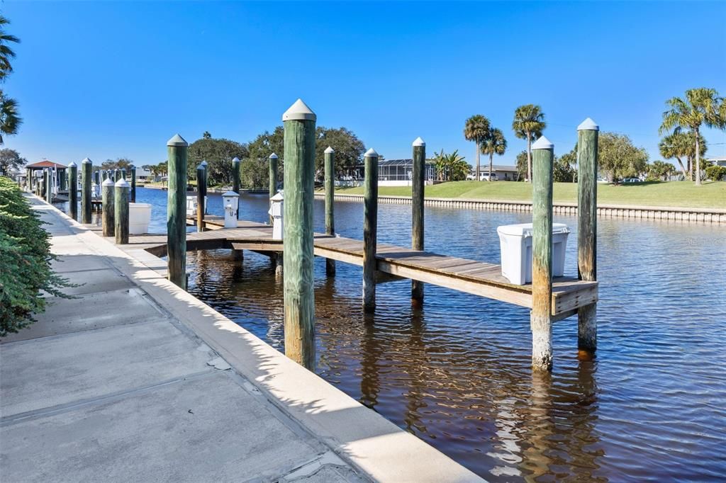 Boat slip with 10,000 lb boat lift, electric and water, and fiberglass dock box available separately.