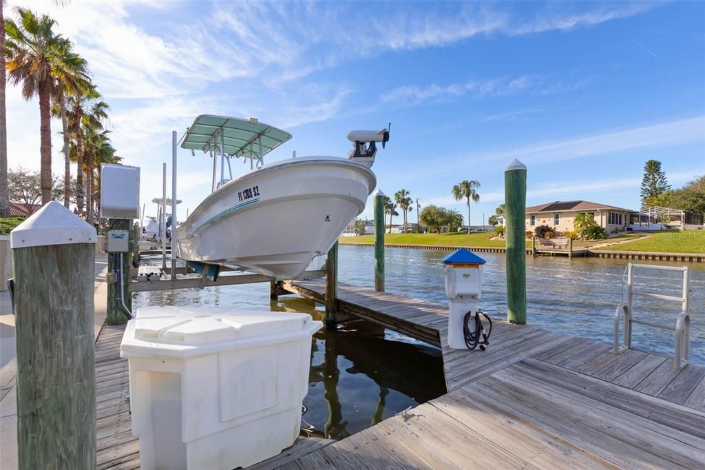 Boat slip with 10,000 lb boat lift, electric and water, and fiberglass dock box available separately.