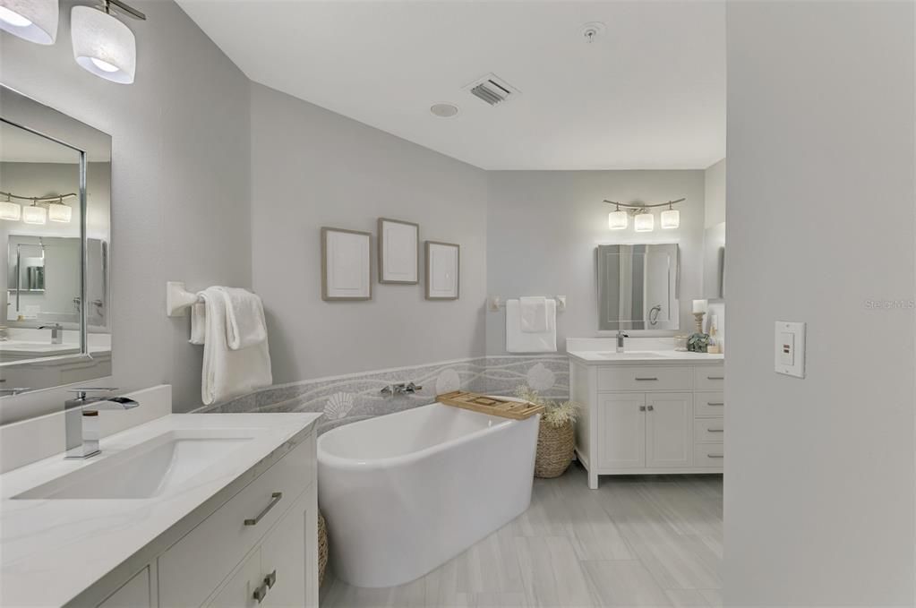 Alot of thought went into this owner's bath renovation. Quartz tops, soaking tub, square sinks and custom tilework.