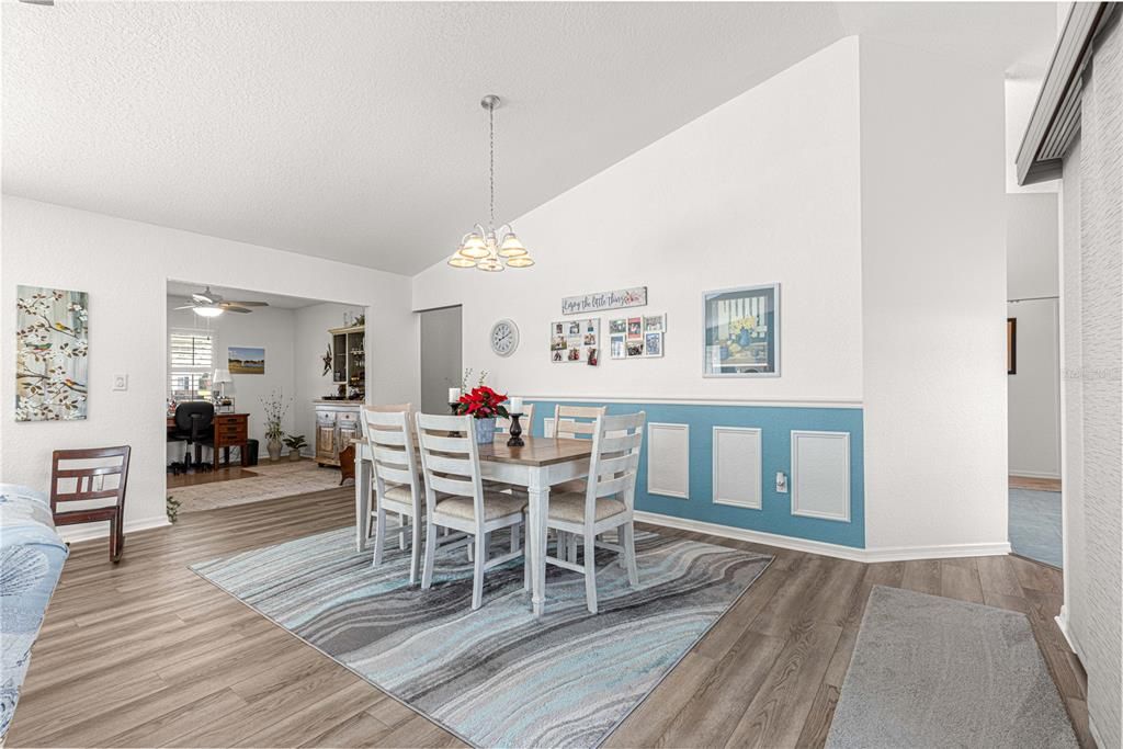 formal dining room with two entrances to kitchen and access to study/den