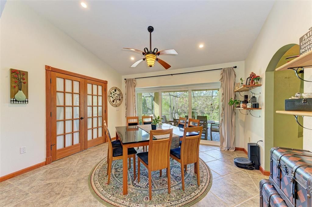 dining room with Impact sliders that lead to the pool patio