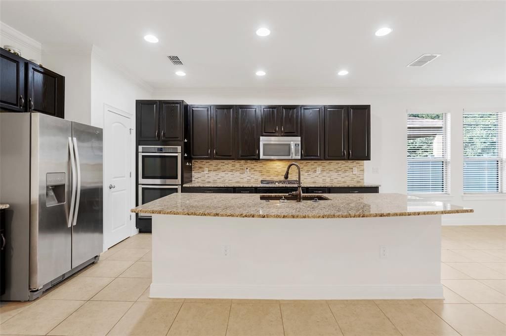 kitchen with gas range and granite countertops