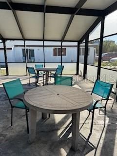 patio next to pool inside enclosure