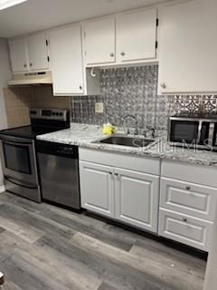 Kitchen stainless steel range, dishwasher and fridge.