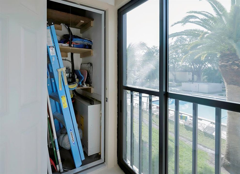 Storage closet with A/C compressor.