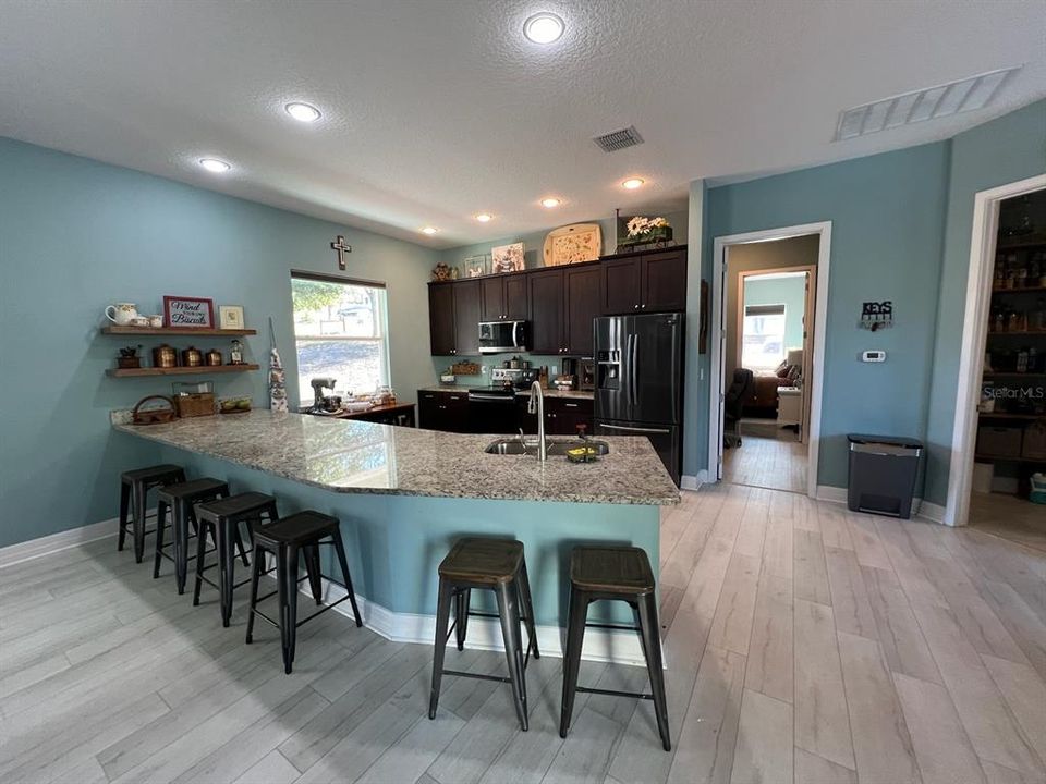 Kitchen with stainless appliances, 42" cabinets and huge eat in breakfast bar.