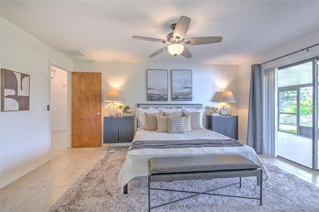 Primary Bedroom with sliding door to the screened in patio