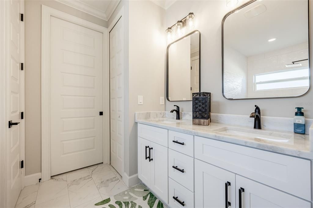 Tiled flooring, Marble Counters, upgraded dual mirrors, faucets, dual sinks and all black hardware throughout.