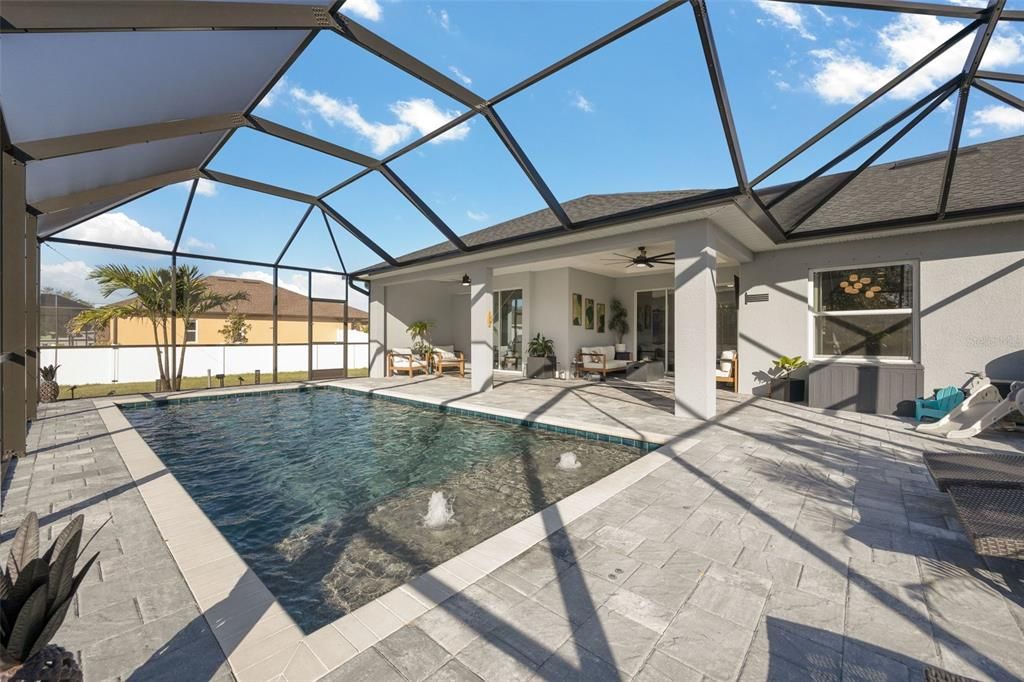 Pool has a "sunning/soaking" ledge with 3 steps leading into pool. Bubblers and an LED Pool light were added. Check out all the outdoor space!