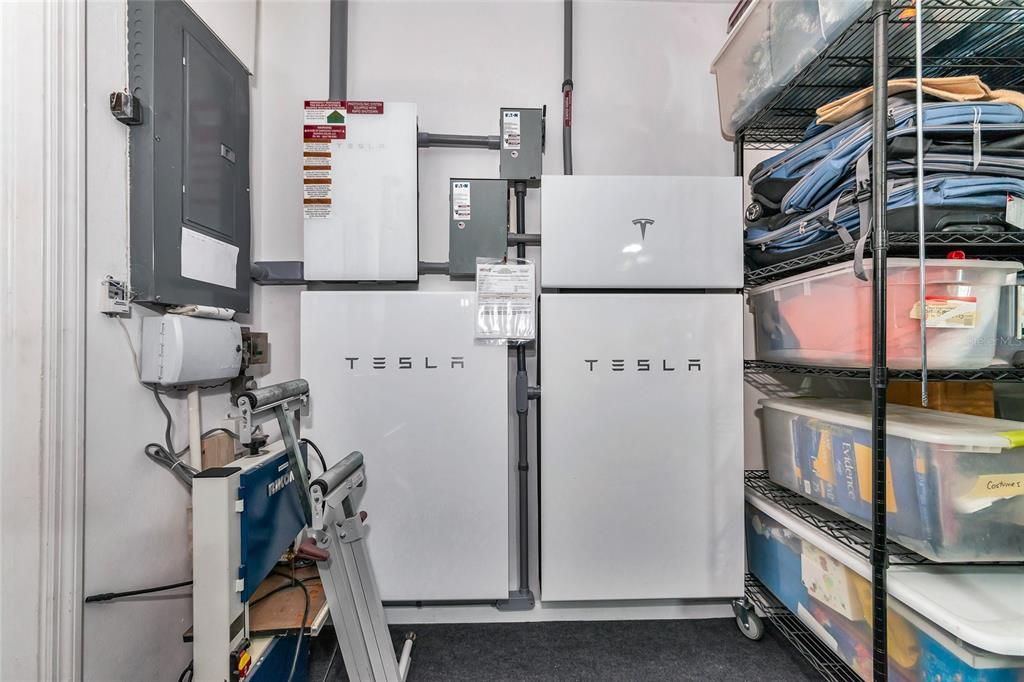 TESLA battery system in garage, powered by roof solar panels.