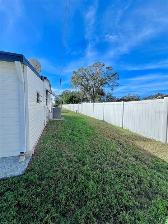 Back of home with vinyl fence