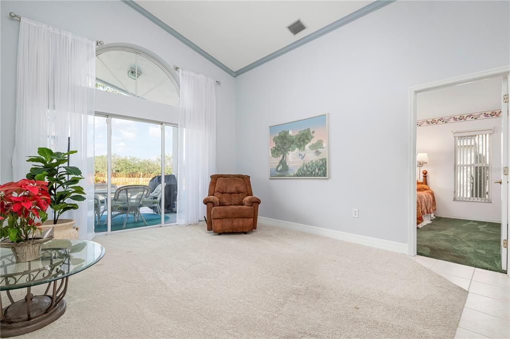 Formal living room with sliders to the pool and pond